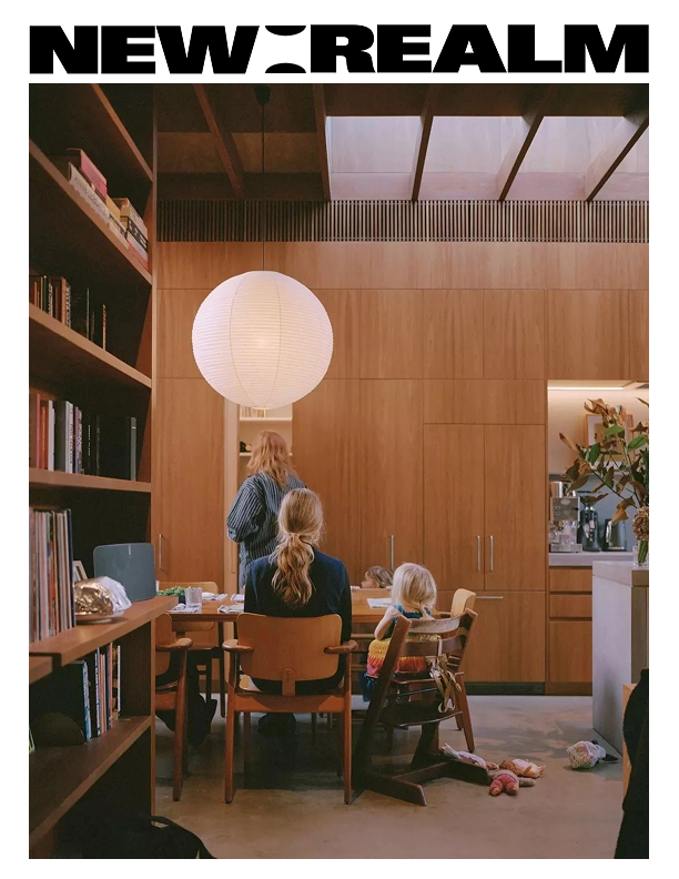 New Realm — a warm family scene gathered around a table in a wood-paneled home.